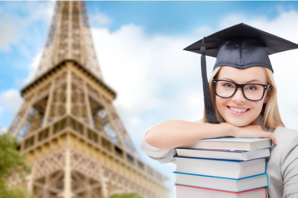 student-in-trencher-with-books-over-eiffel-tower-picture-id8822627624